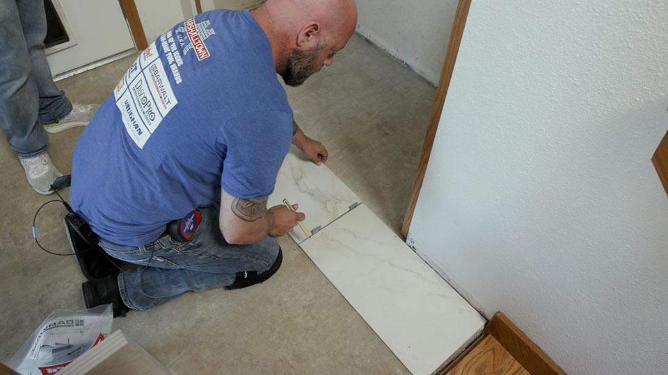 man doing a dry layout of tile